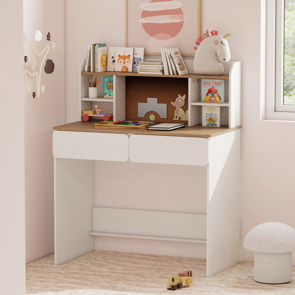 White writing desk with corkboard and shelves styled in a pink child's room.