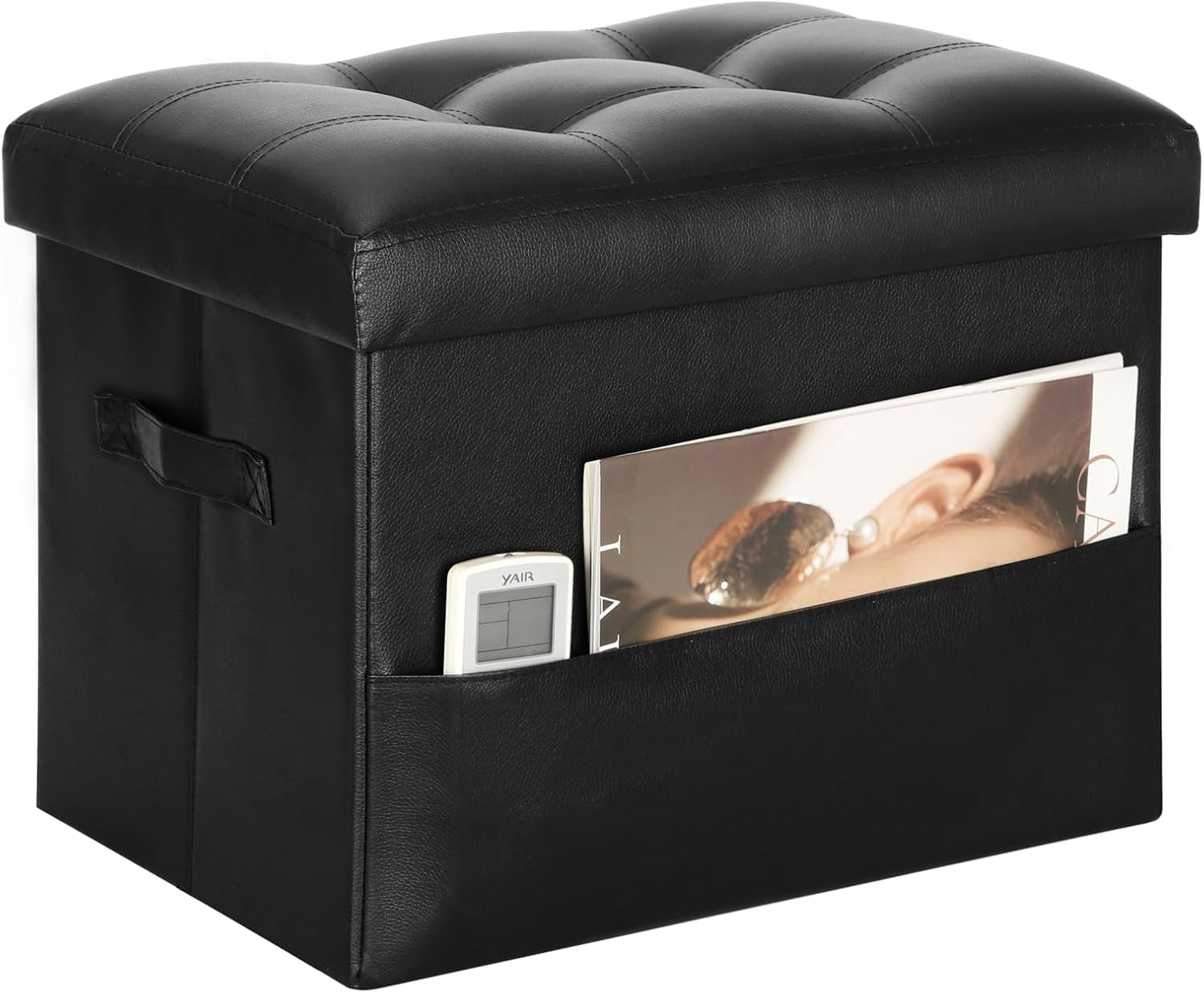 Closed black faux-leather storage ottoman with tufted top and front side pocket holding a magazine and remote.