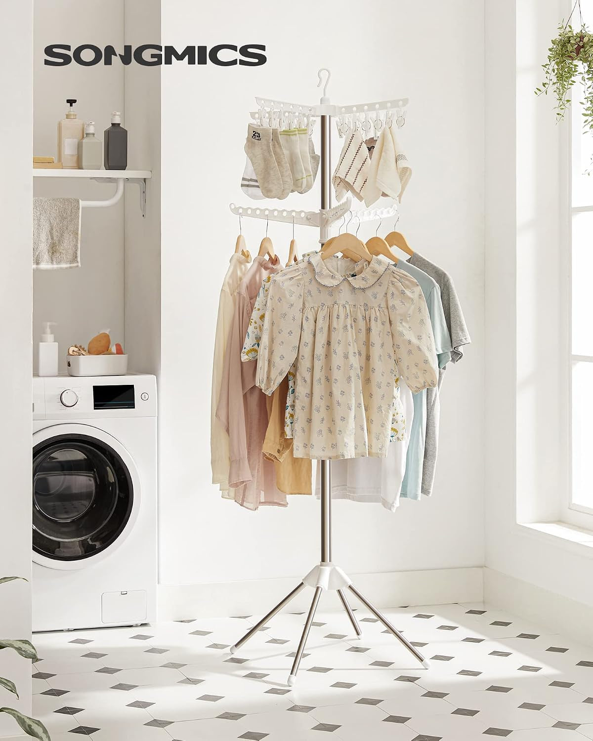 Freestanding drying rack with shirts and socks in a bright laundry room setting, front view