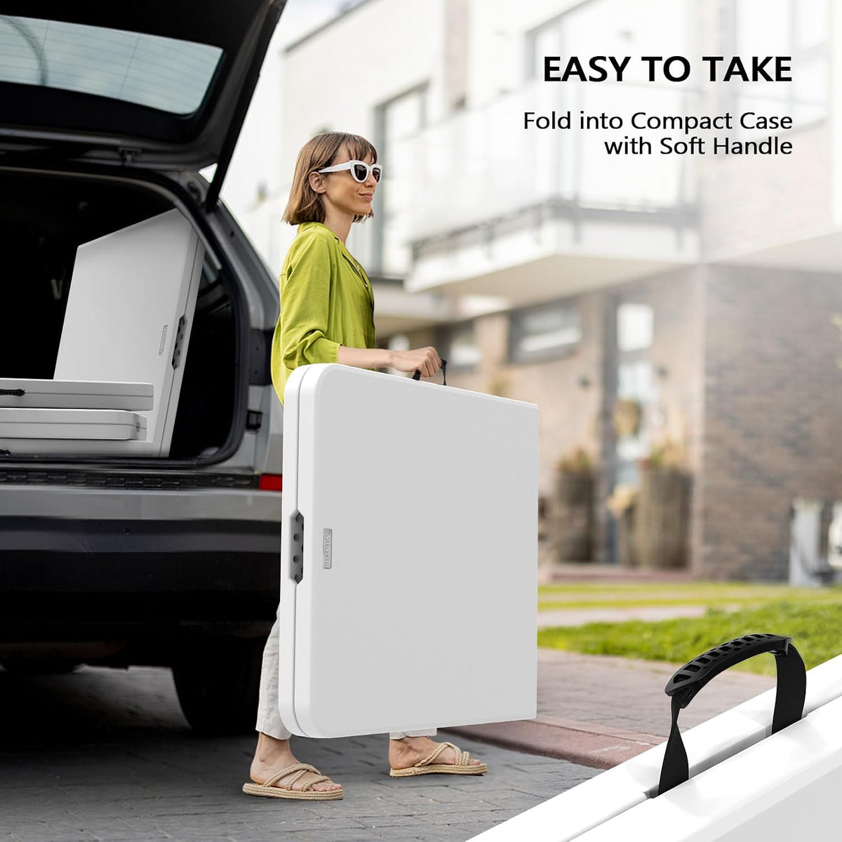 Woman carrying a folded white table by its handle next to an open car trunk.