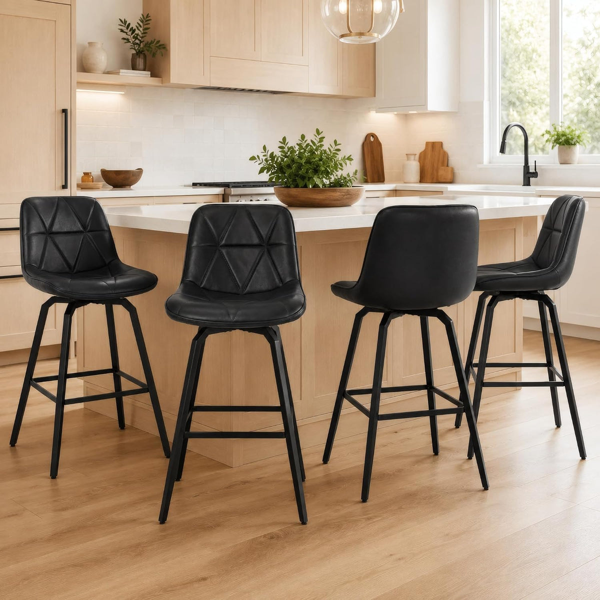 Four black counter stools arranged at a light wood island with a potted plant centerpiece