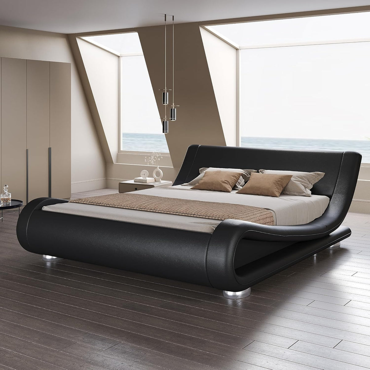 Angled front-right view of a black faux leather wave bed in a bright room with ocean-view windows