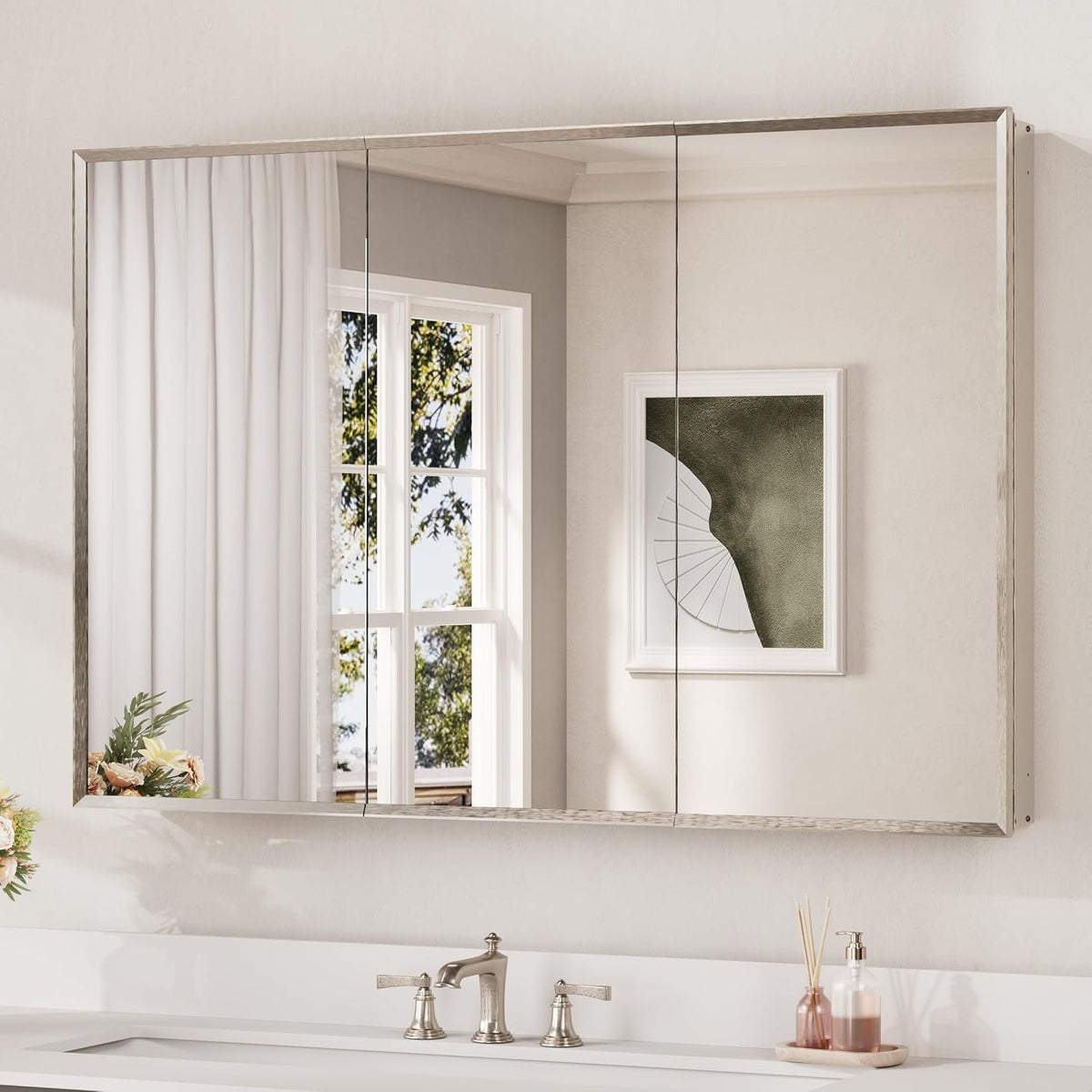 Wide brushed-silver mirrored cabinet with three mirrored panels above a bathroom sink.