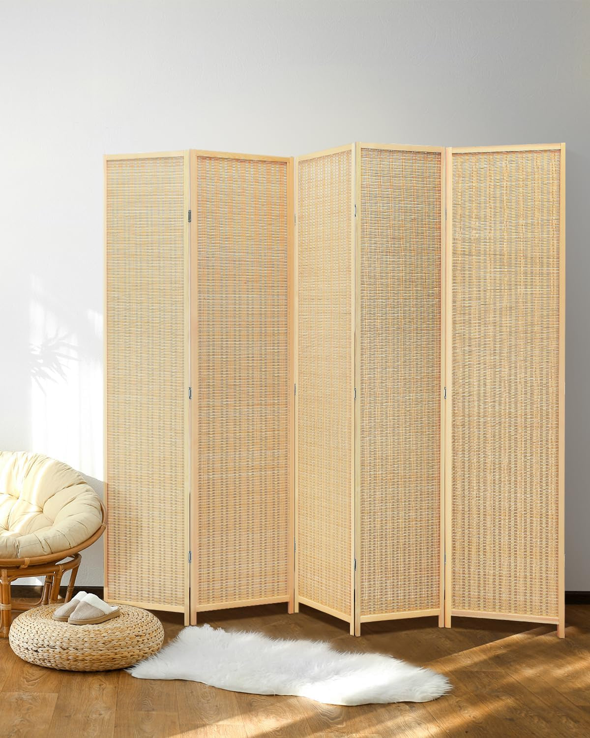 Full front studio shot of a four-panel natural bamboo folding screen on a wood floor with soft rug