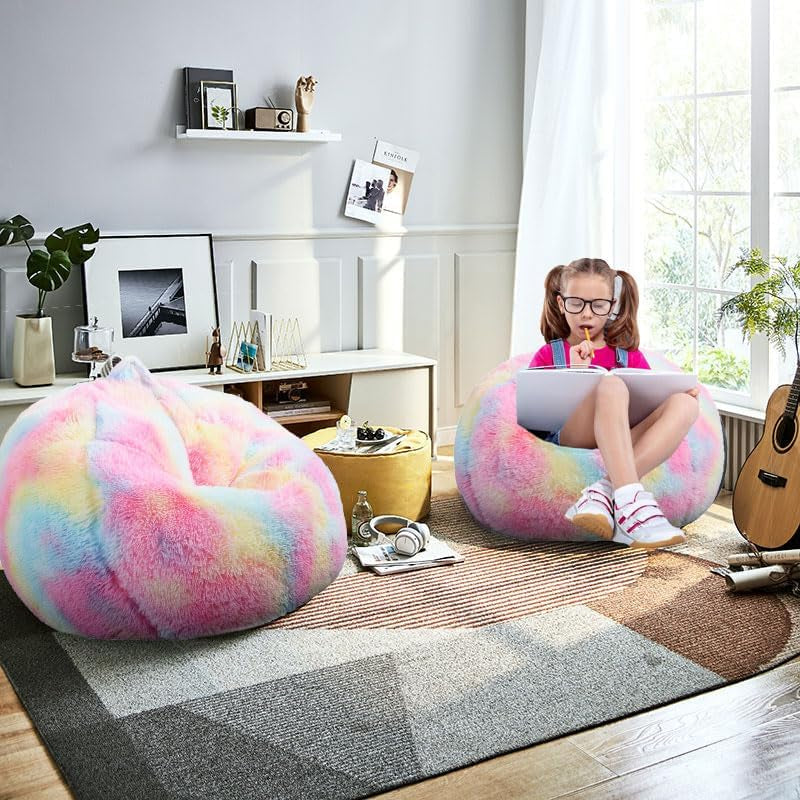 Sunlit living room with two pastel rainbow round bean bags; a child sits on one writing.