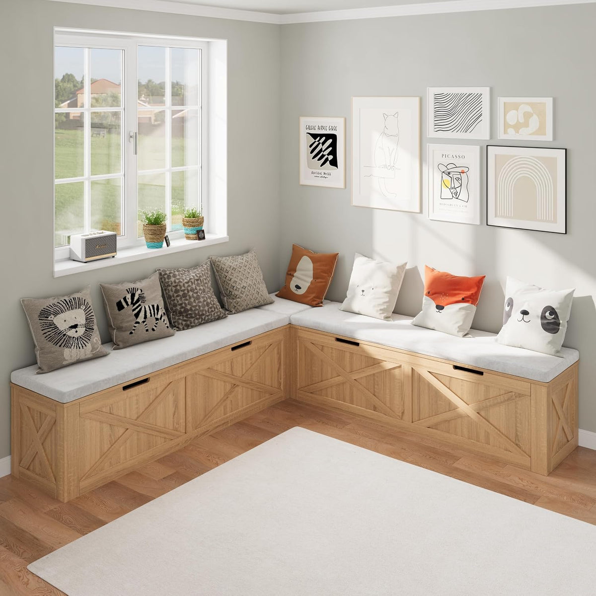 Corner dining nook with L-shaped light-wood storage bench, light-gray cushion, animal-print pillows and framed wall art.
