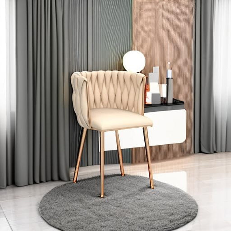 Beige velvet dining chair styled beside a vanity with curtains and decorative accessories