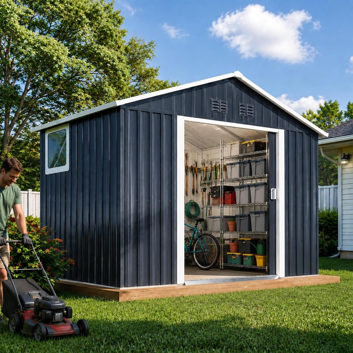 Dark charcoal metal outdoor shed with white trim, angled front view on a backyard lawn with open sliding door