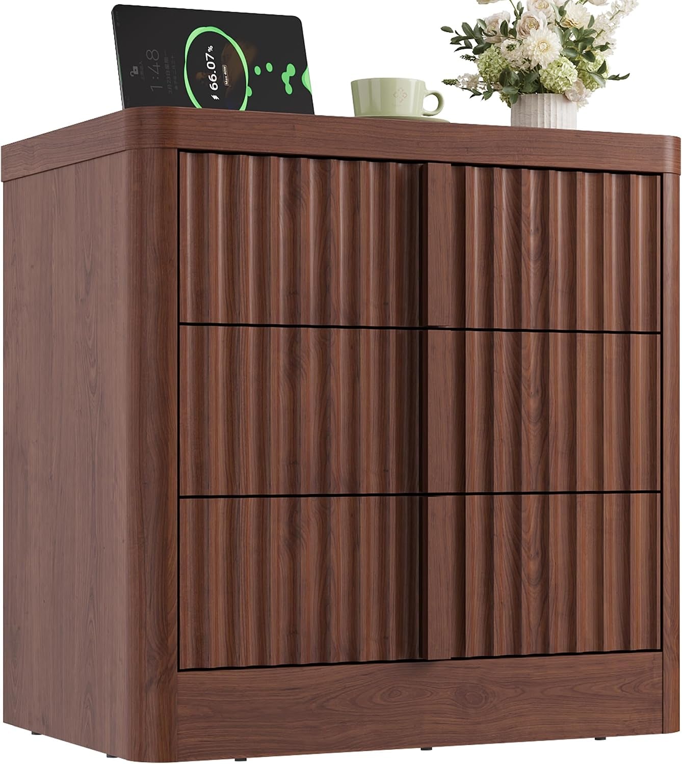 Front three-quarter view of a dark brown fluted nightstand with a tablet, cup, and flowers on top.