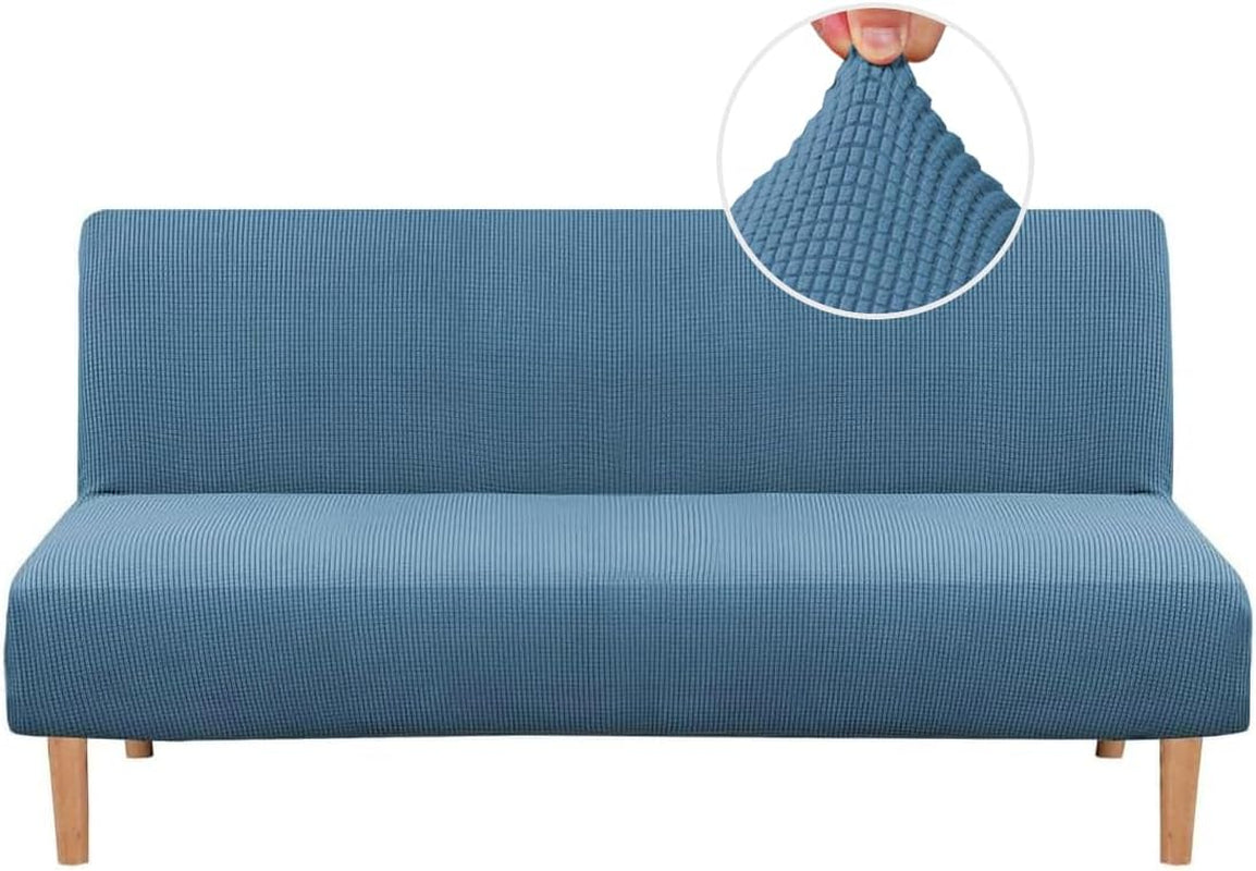Front-facing futon in a medium blue textured small-check slipcover with an inset close-up showing the fabric being pinched.