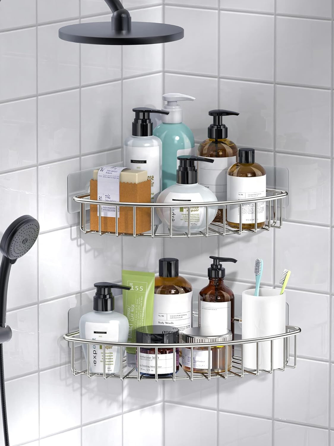 Two stainless steel corner shelves installed in a white tiled shower holding bottles and toiletries at different heights