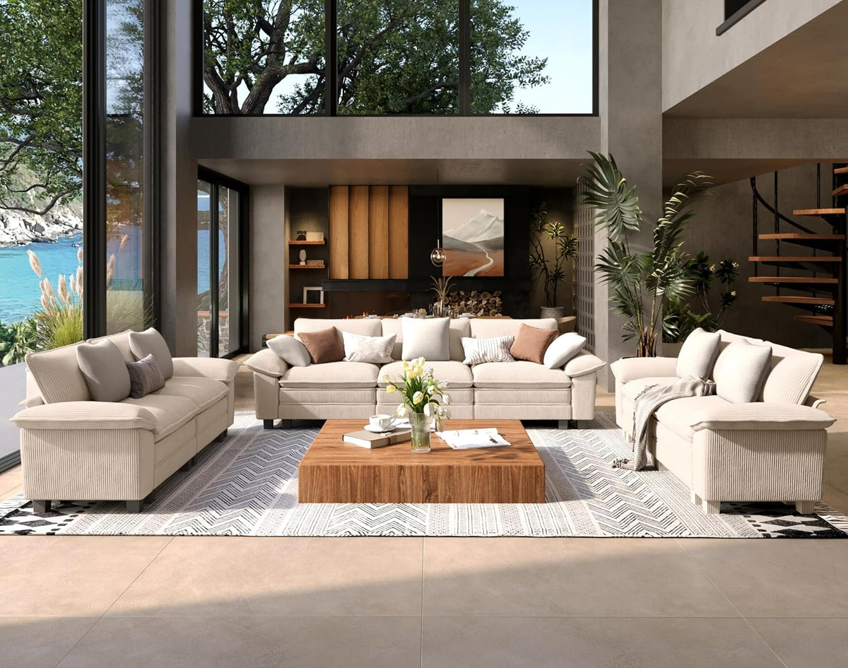 Spacious living room with white three-seat sofa, two matching loveseats, wood coffee table and large windows.