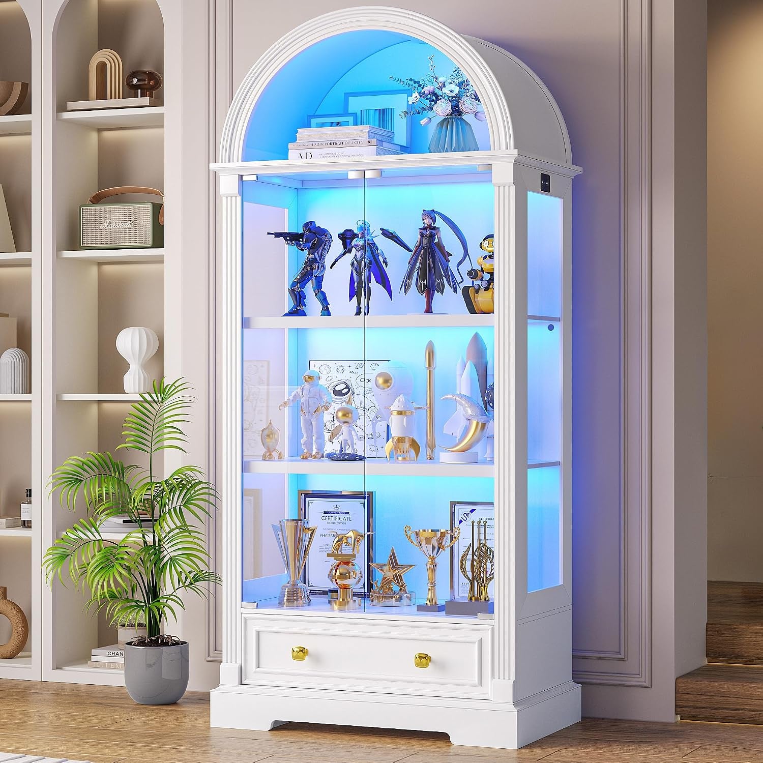 Tall arched white display cabinet with glass doors and blue lighting, staged with awards and figurines.