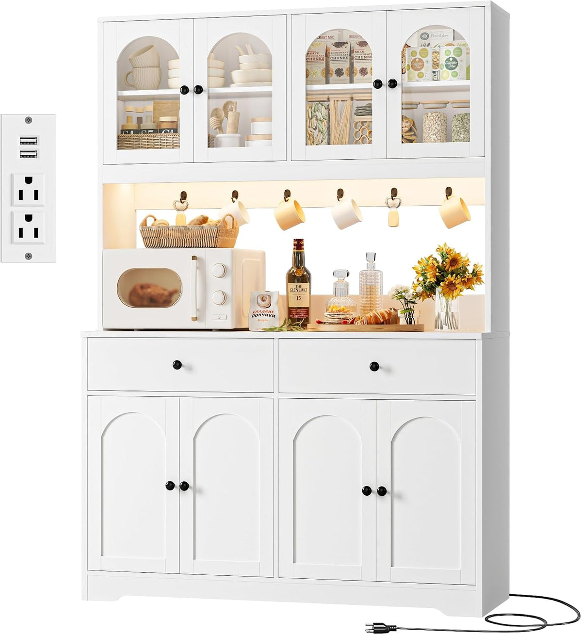 White pantry shown front-on with mugs on hooks, countertop styling and a visible power cord trailing from the base