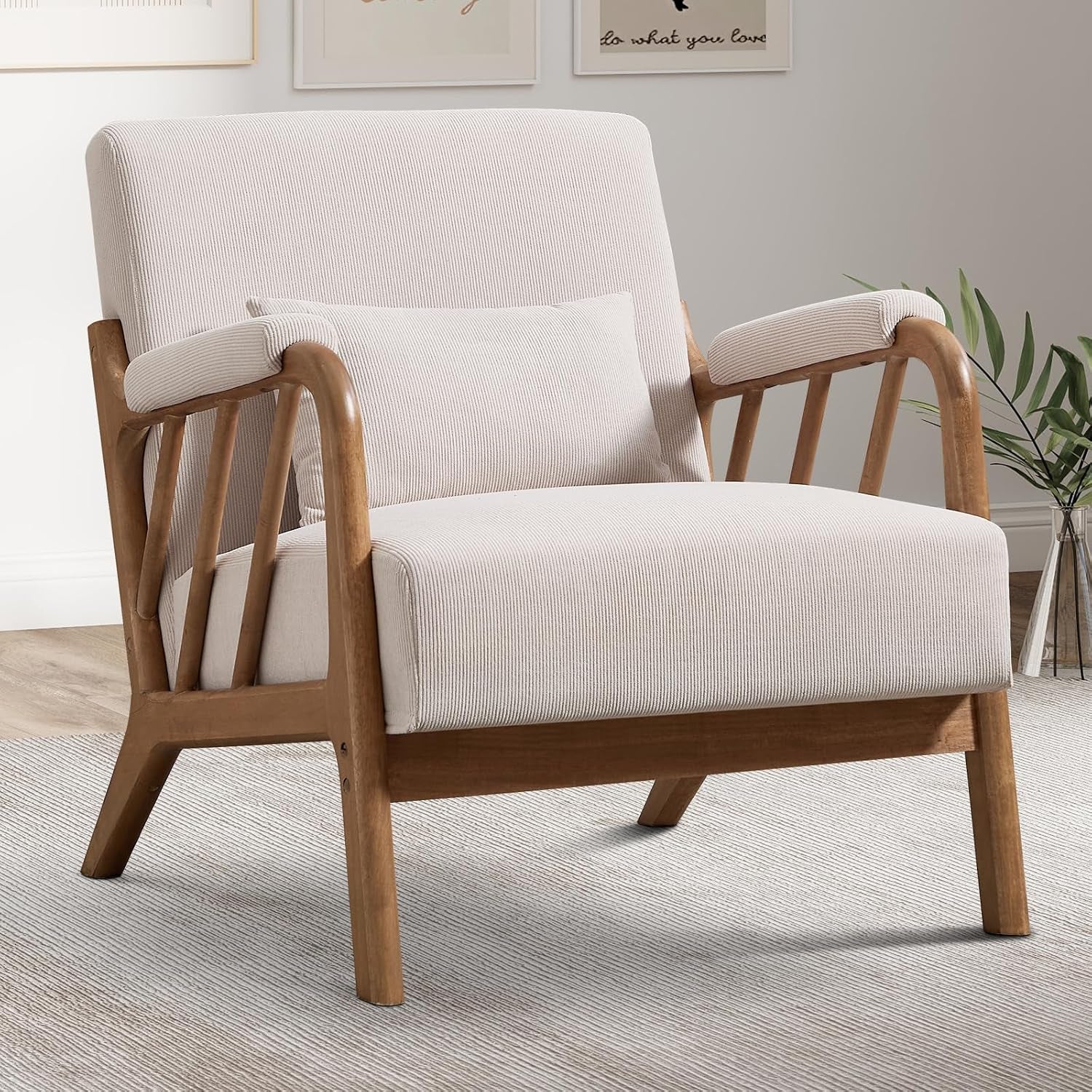 Light beige upholstered mid-century accent chair with angled wooden frame and lumbar pillow