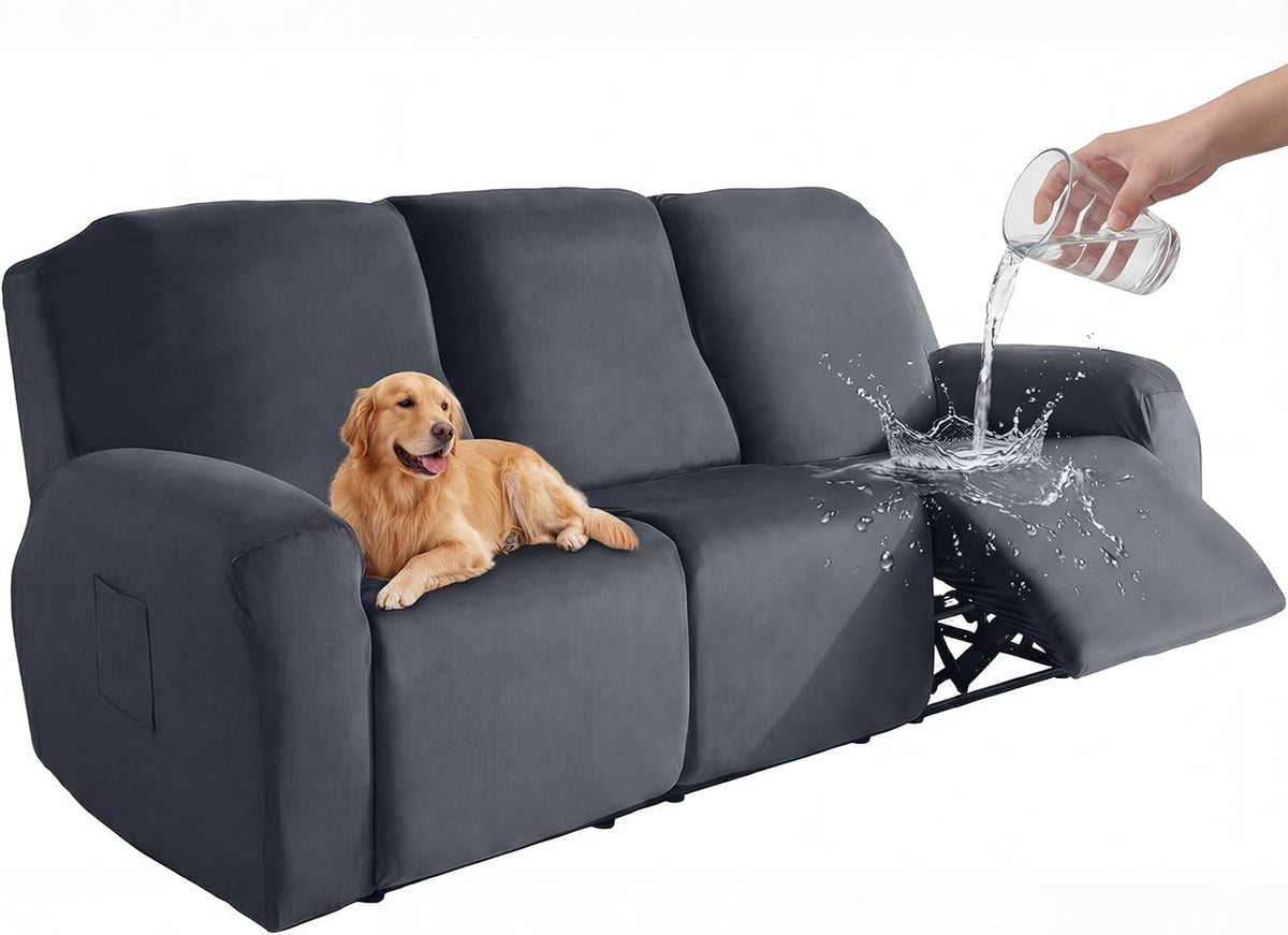 Dark grey velvet 3-seat recliner slipcover front view with a dog on the seat and water splashing on the open recliner