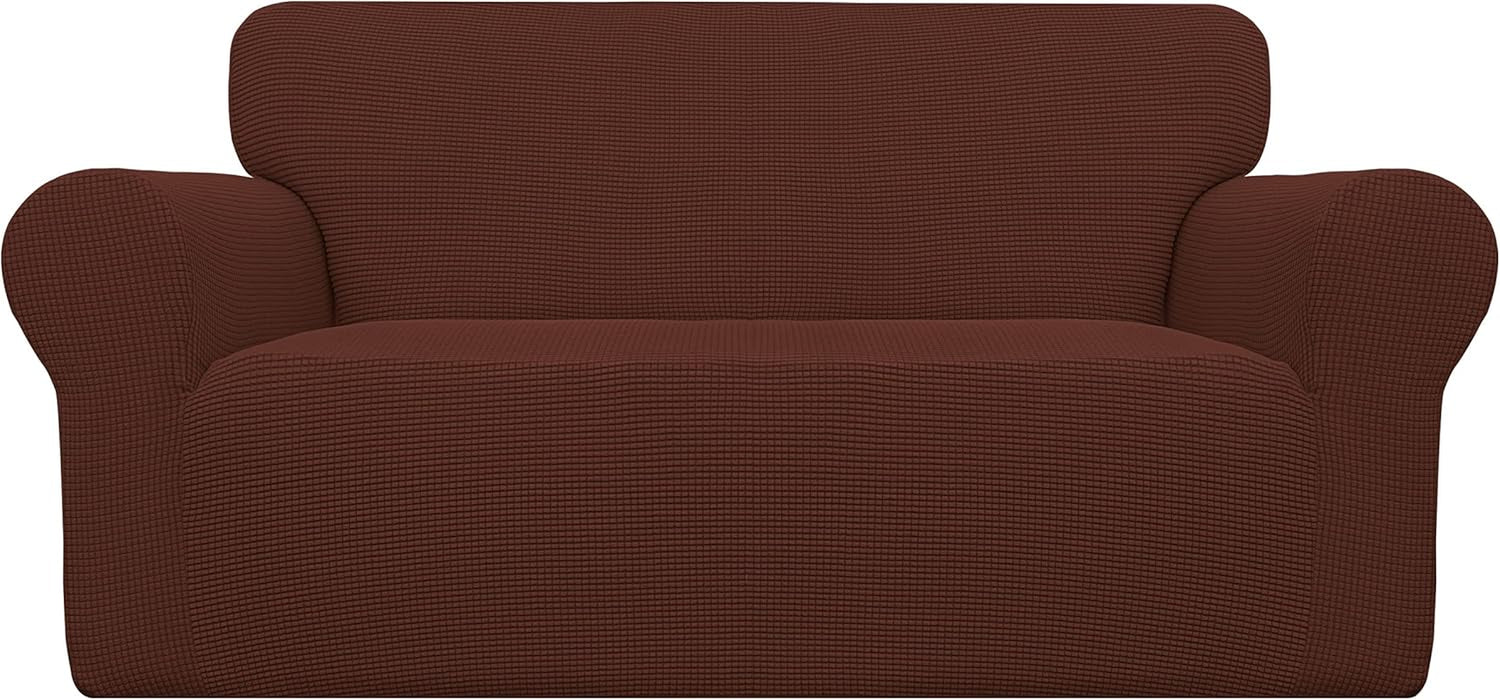 Front view of a rust-brown loveseat cover emphasizing uniform waffle texture and gently rounded arm contours.