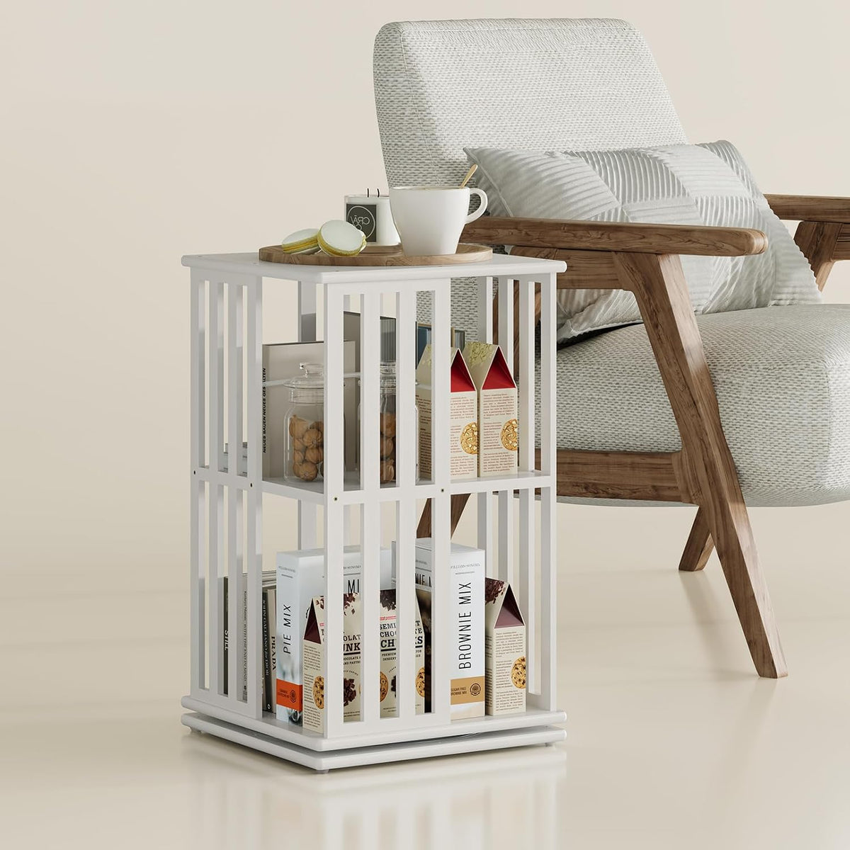 White two-tier square bamboo bookcase beside a wooden-framed armchair, styled with a mug and boxes on and inside the shelves.