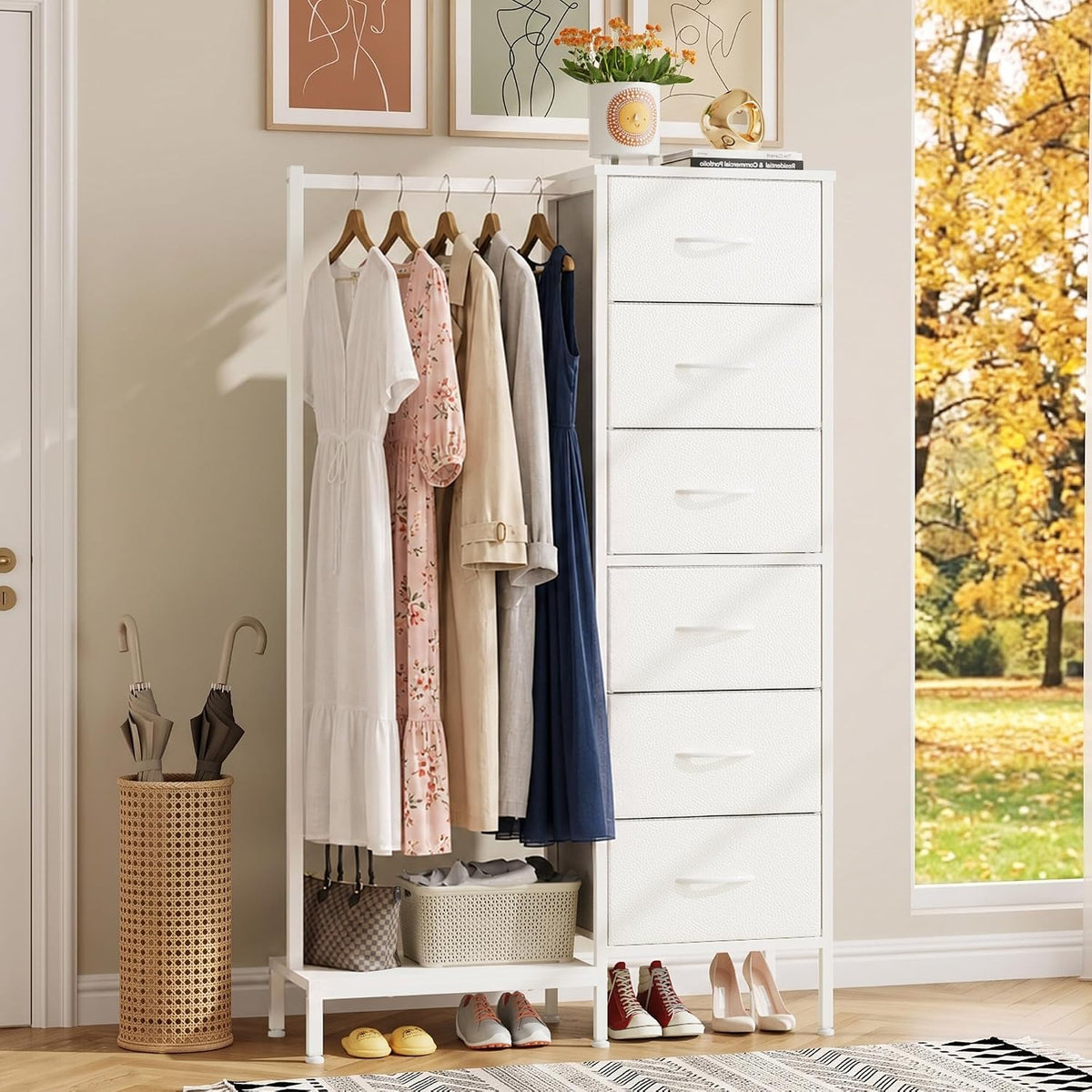 Tall white dresser with attached open hanging rack holding dresses, shoes below and umbrella stand at side.