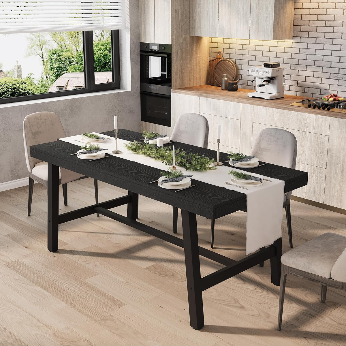 Rectangular black wood-top table with black metal legs set with plates and runner in a bright kitchen.