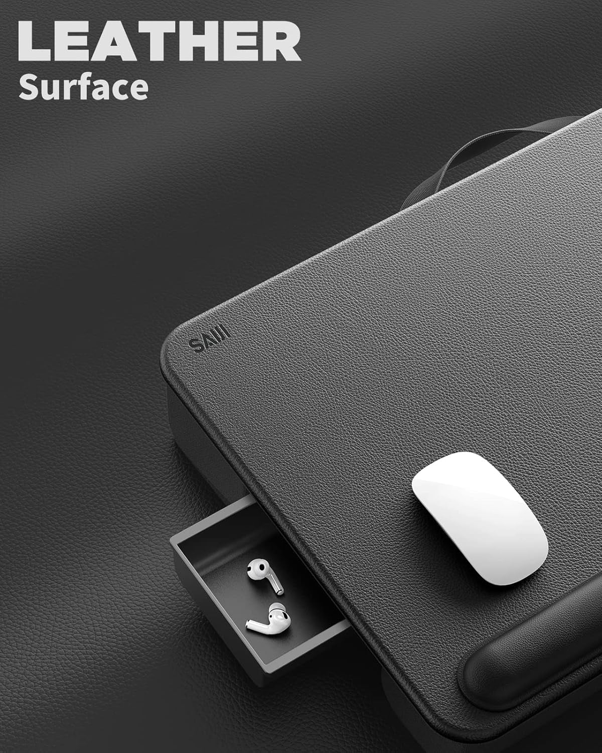 Close-up of a black leather-textured lap desk corner with a white mouse and a small pull-out drawer holding earbuds.