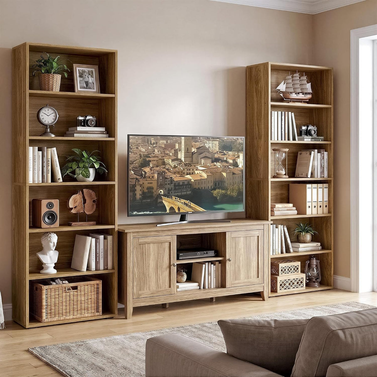 Pair of oak brown 6-tier bookcases flanking a TV stand in a living room setting, front view