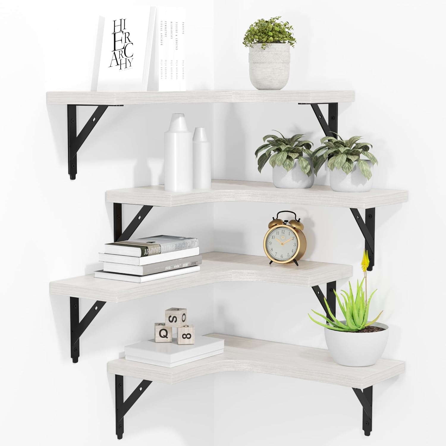 Corner display of four whitewashed wood L-shaped floating shelves with black metal brackets and decor