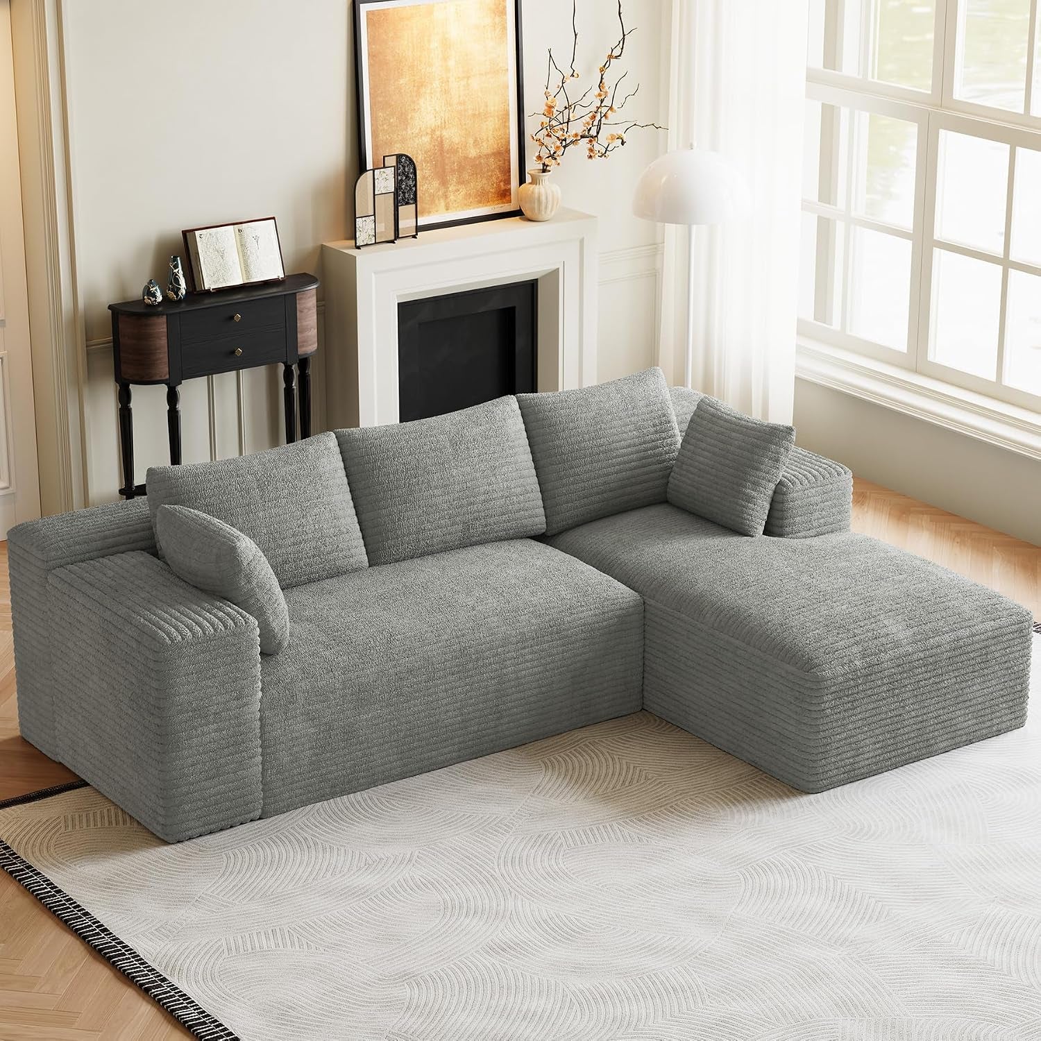 Light gray L-shaped modular sectional with chaise in a bright living room