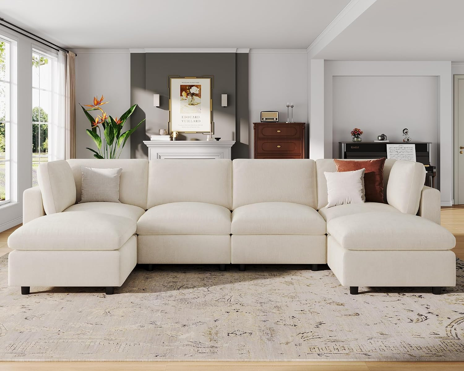 Front view of a modular cream sectional with chaises on both ends set in a spacious living room.