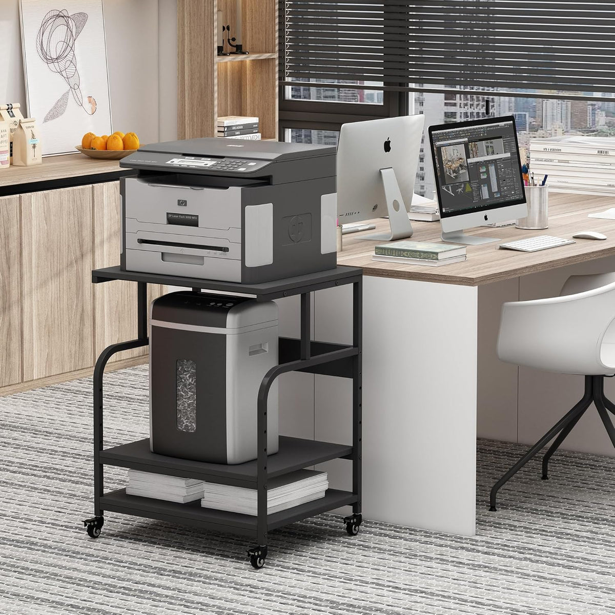 Black three-tier stand beside a desk holding a large copier on the top shelf and a paper shredder on the middle shelf.