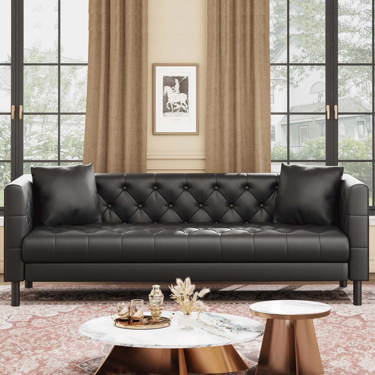 Front view of a black tufted three-seat sofa with two matching pillows placed in front of tall windows.