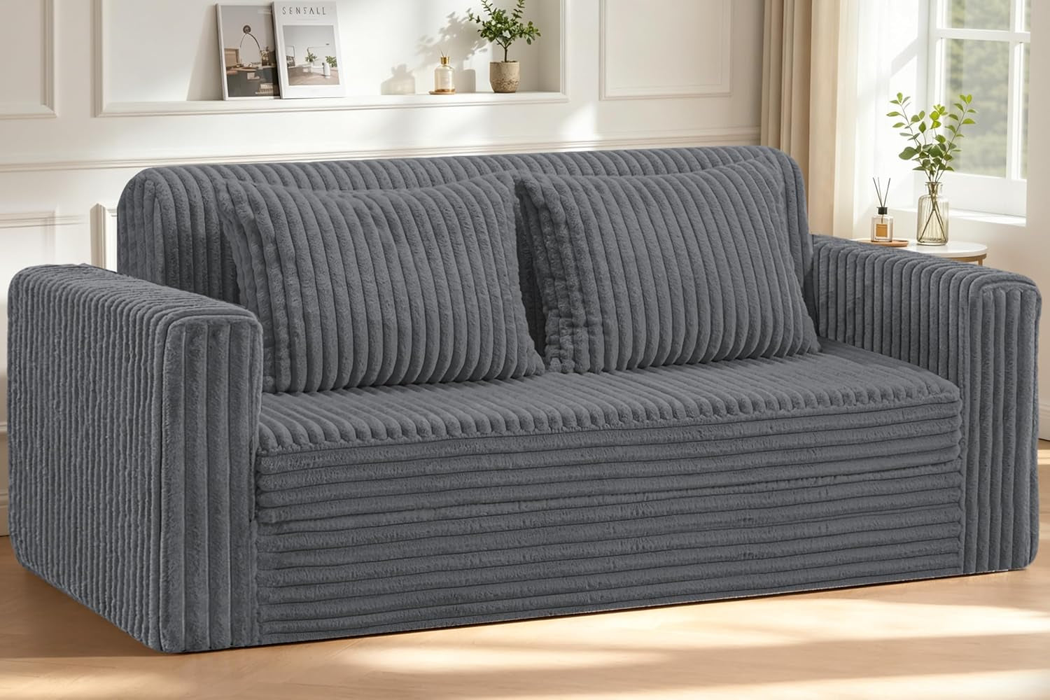 Three-seater ribbed plush sofa in charcoal gray with two matching back cushions against a paneled wall.