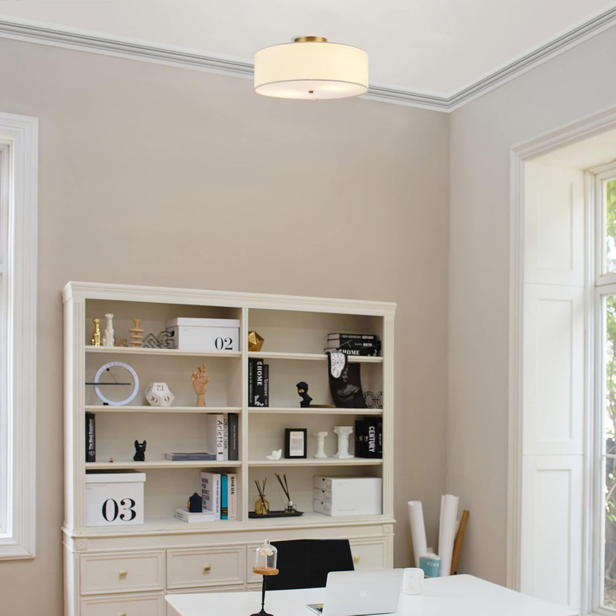 Matte brass and white linen flush mount installed on a home office ceiling centered above a desk