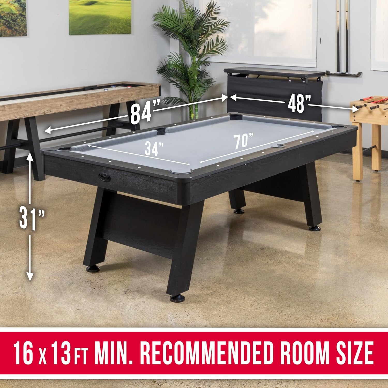 Angled view of a black pool table with arrows showing room and table measurements in a showroom setting.