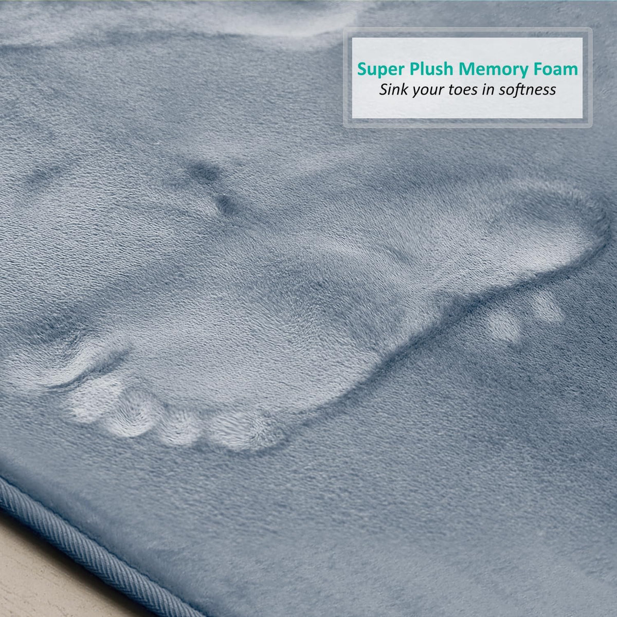 Close-up of stone-blue plush surface showing a footprint impression in the memory foam.