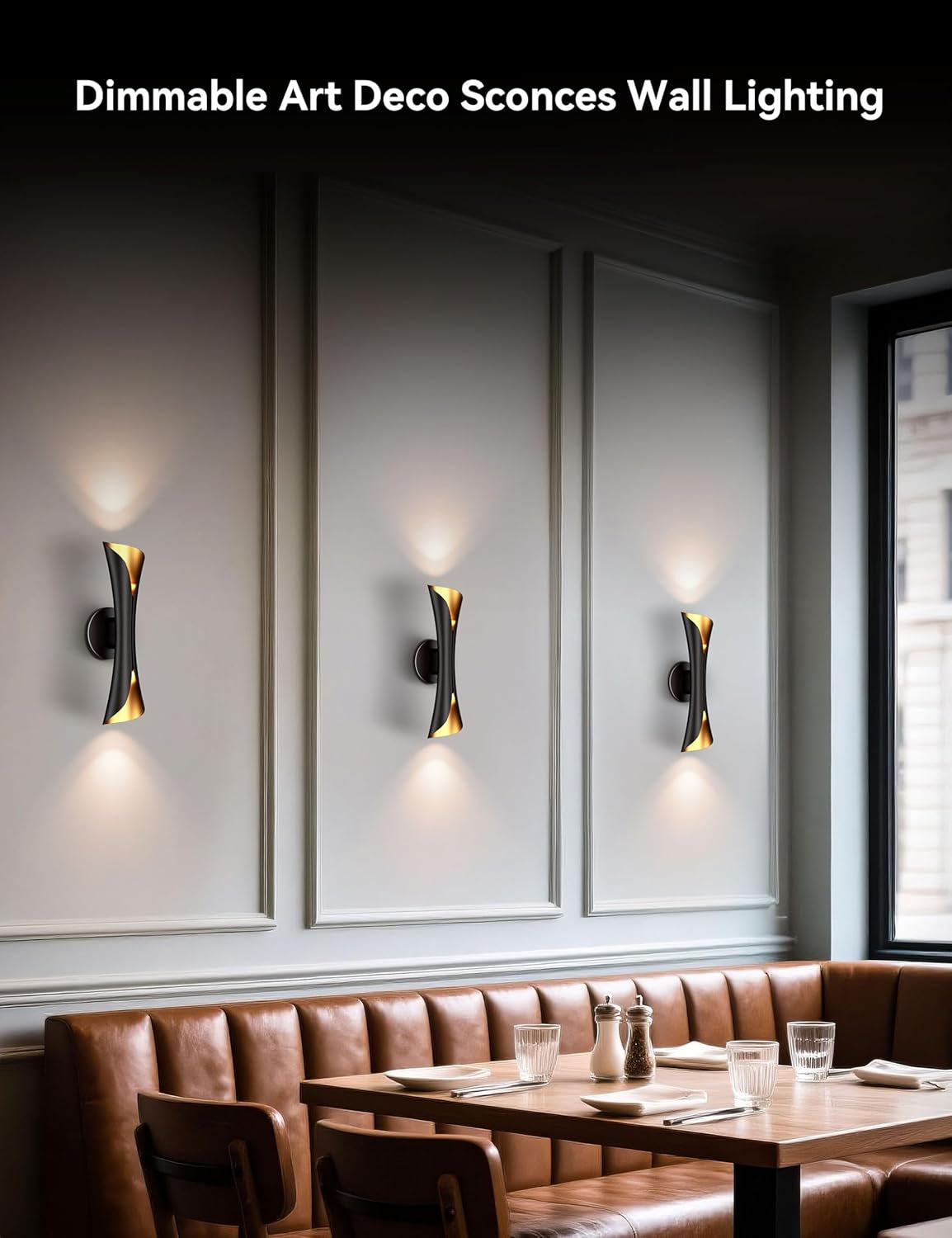 Three wall sconces mounted above banquette seating casting up-and-down warm light.