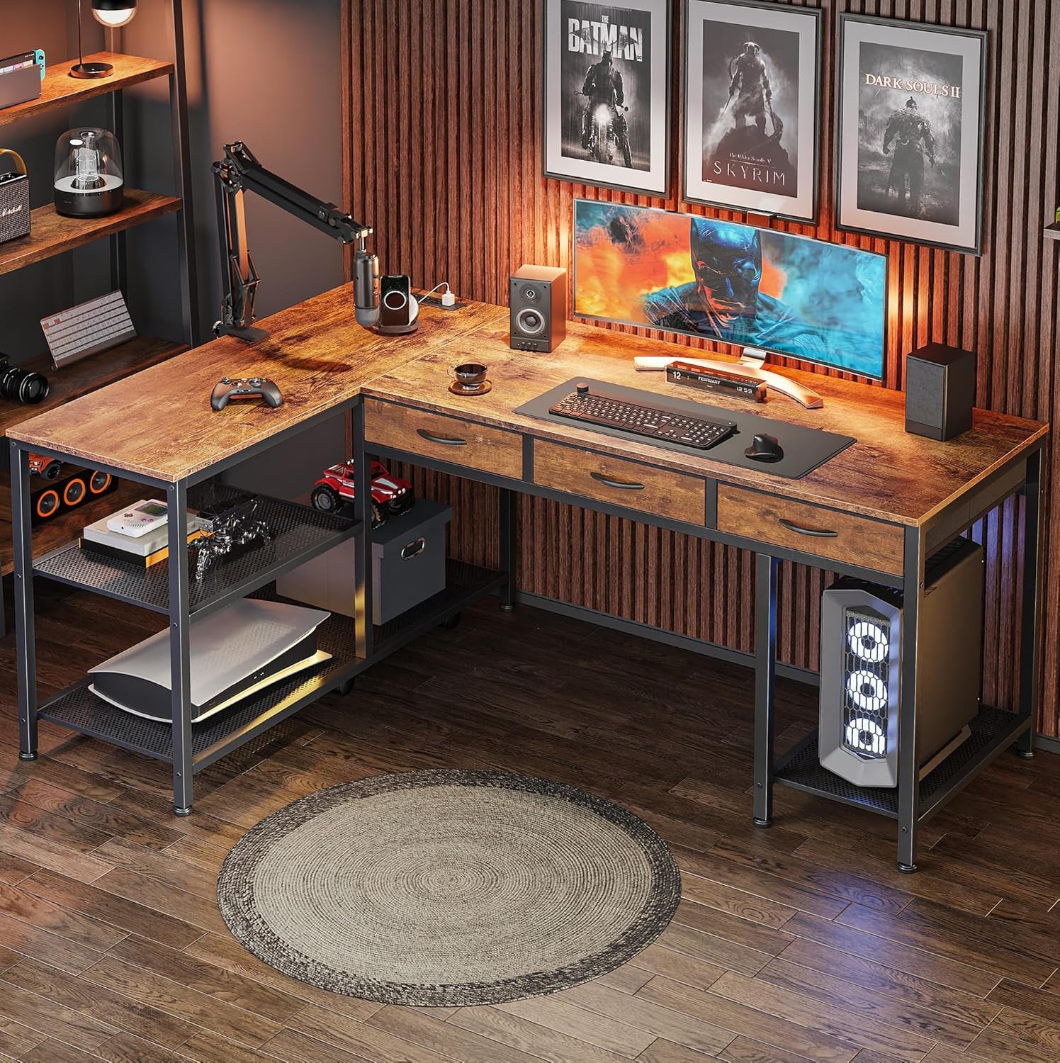 Moody gaming corner with the L-shaped desk, dual ultrawide monitor, ambient lighting and game posters on the wall.