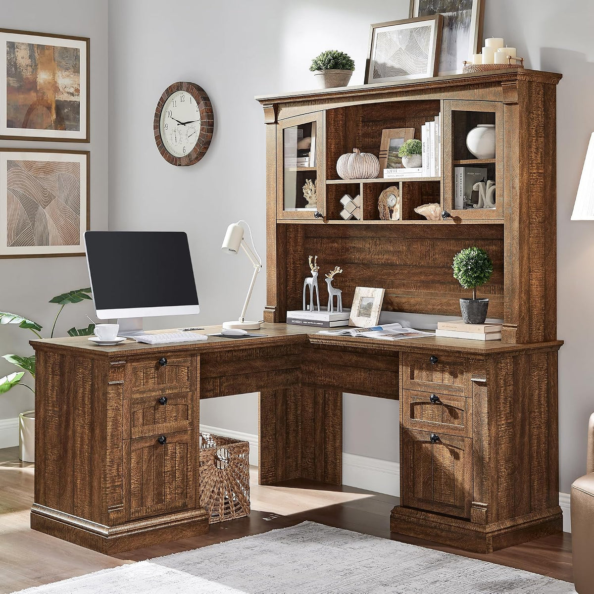L-shaped desk in a warm brown wood finish with hutch, desktop accessories, and wall art.