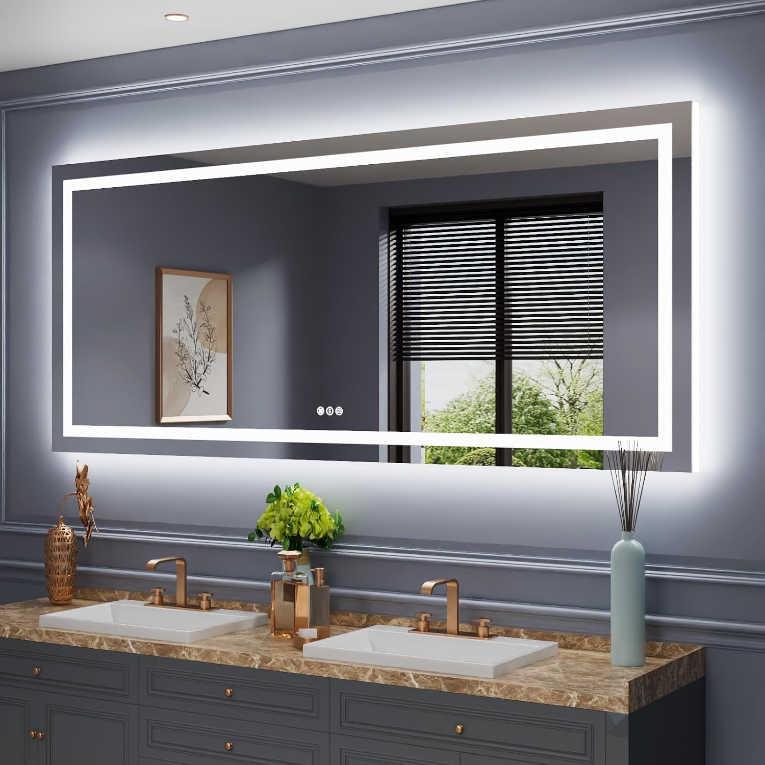 Wide LED mirror with bright rectangular light band reflecting a window and framed art above a double sink vanity.
