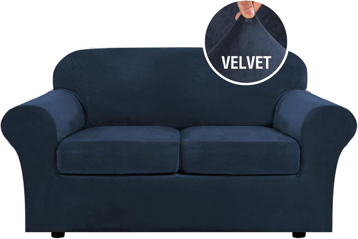 Front view of a navy blue three-cushion sofa with a round close-up inset of someone pinching the plush velvet.