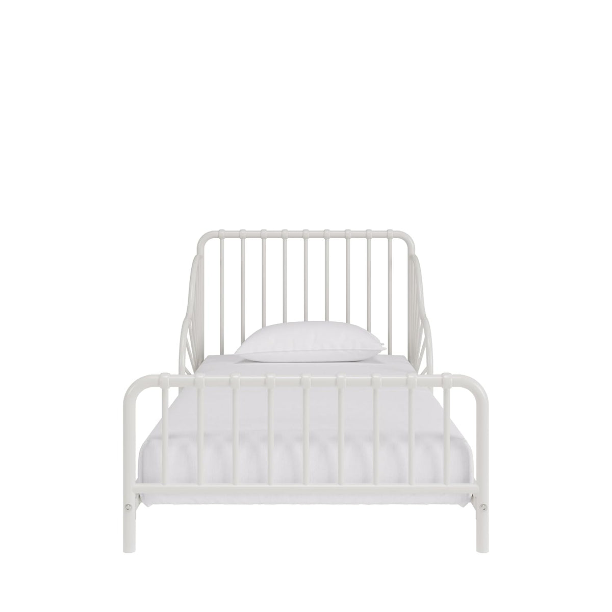 Front-facing view of an off-white metal toddler bed with vertical slats and pillow on mattress