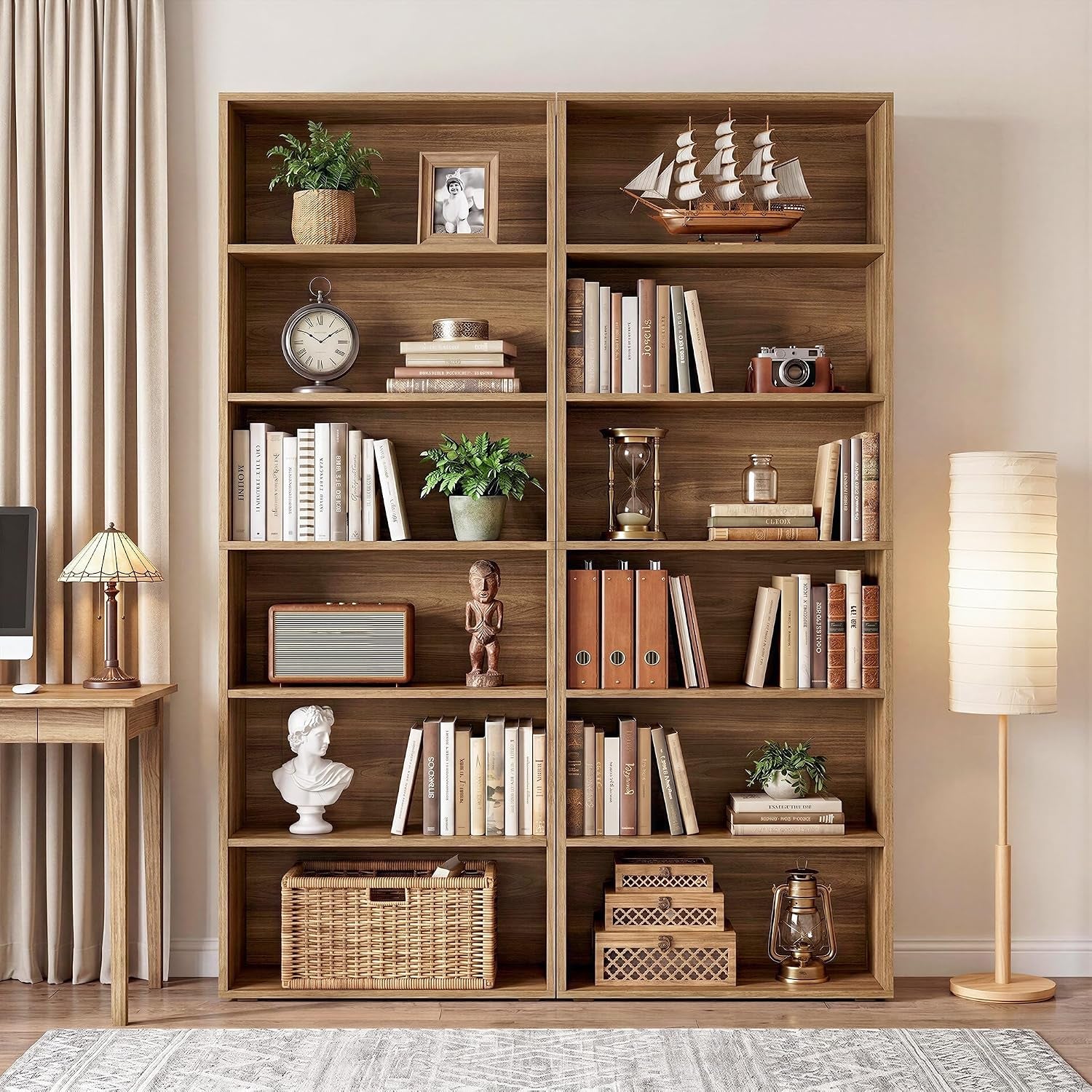 Two oak brown 6-tier bookcases styled with books, baskets and decor in a living room, front view