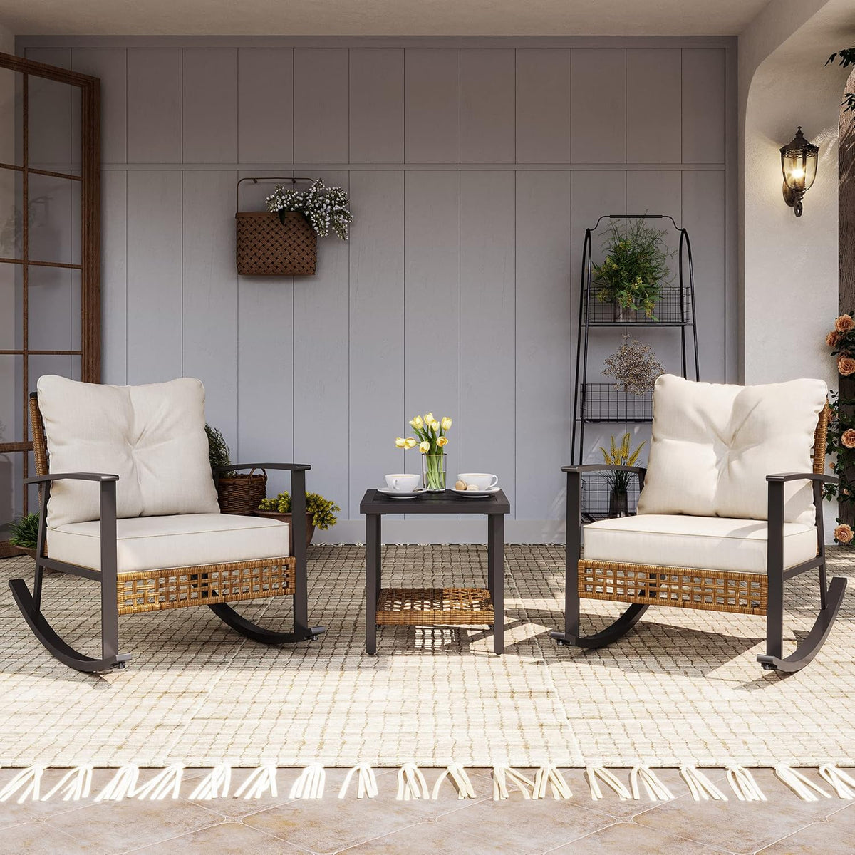 Beige rattan and metal 3-piece rocking bistro set with two cushioned rocking chairs and a two-tier coffee table, front view