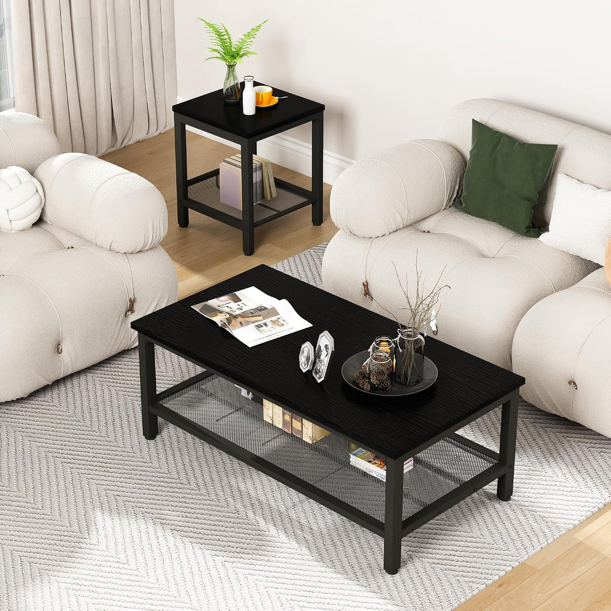 Living room view with a black coffee table and matching square end table beside beige sofas.