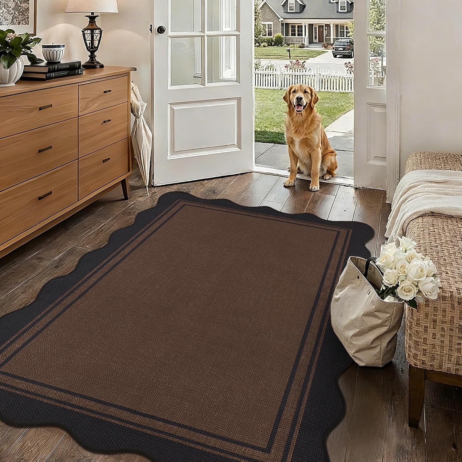 Entryway with a brown scalloped rug and a golden retriever sitting in the doorway