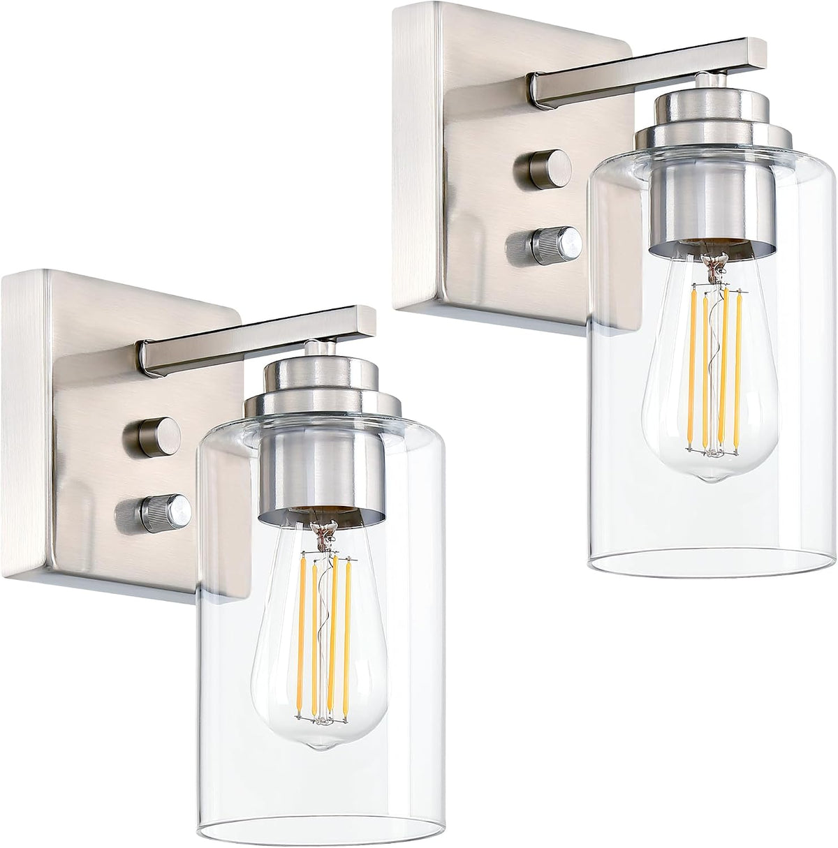 Pair of brushed nickel-finish sconces with clear glass shades shown in a cropped close-up.