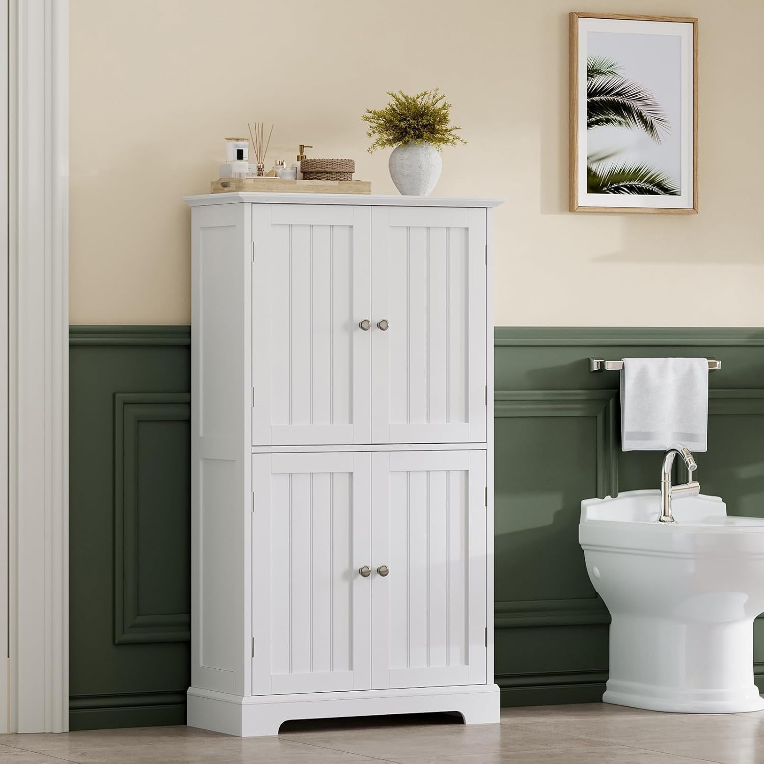 White freestanding cabinet staged in a bathroom beside a toilet, full front view