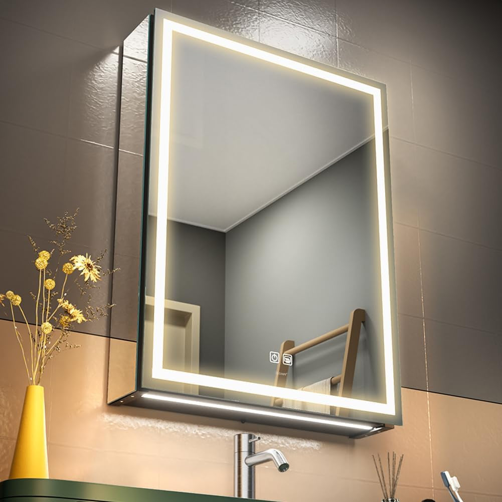 Wall-mounted rectangular LED mirror with illuminated border and a small shelf below, shown above a faucet.