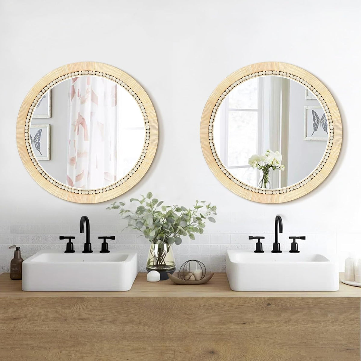 Two identical round rattan mirrors with wooden bead trim installed above a double vanity