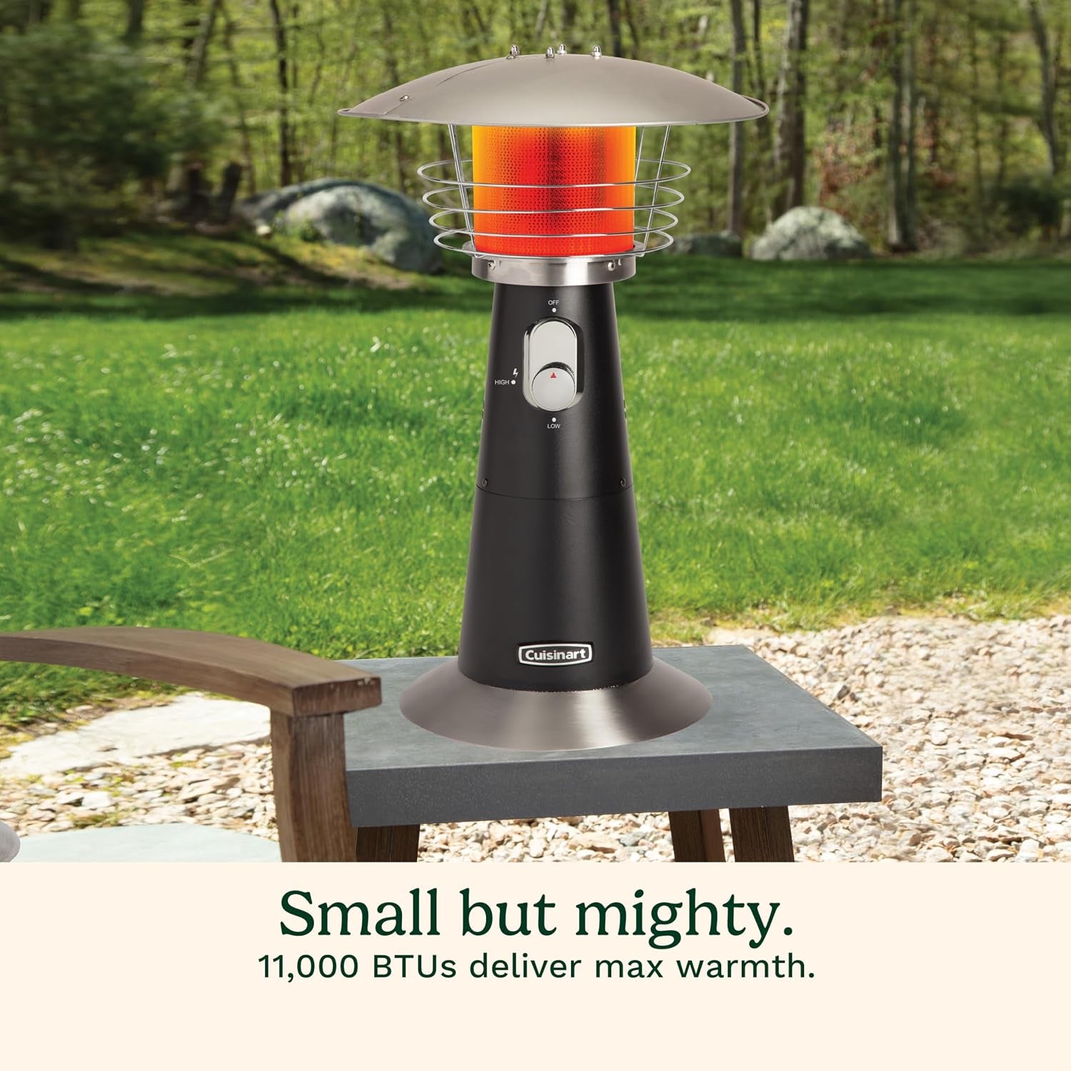 Black tabletop patio heater on a small outdoor table in a backyard setting